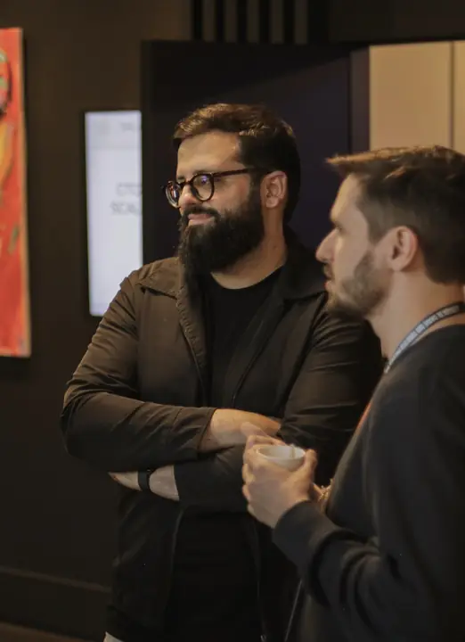 Dois participantes conversando no intervalo